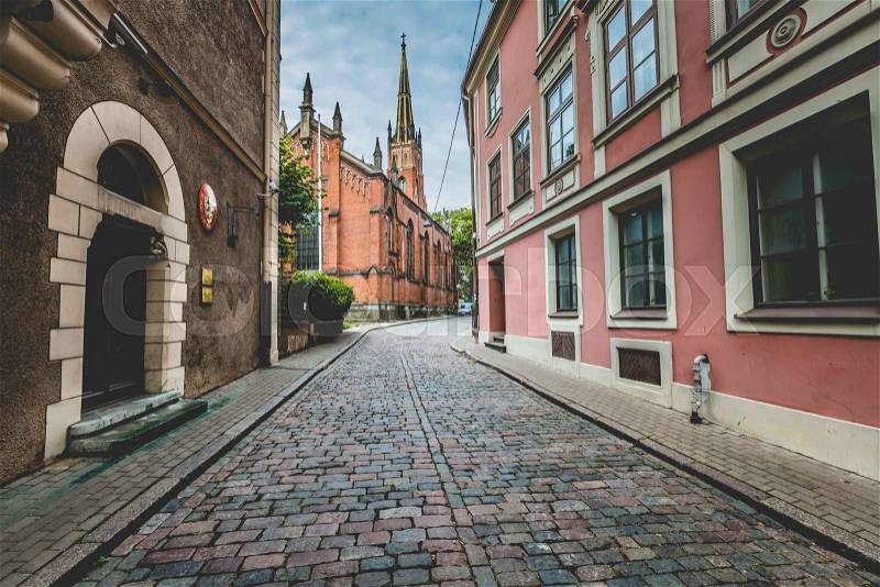 Morning street in medieval town of old Riga city, Latvia. Walking through medieval streets of old Riga, tourists can find unique architectural ensembles and ancient houses, stock photo