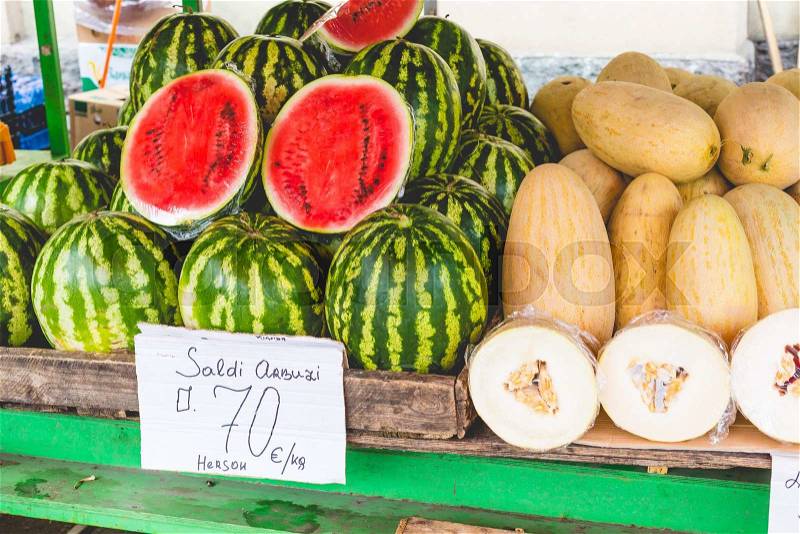 Many big sweet green watermelons and one cut watermelon, stock photo
