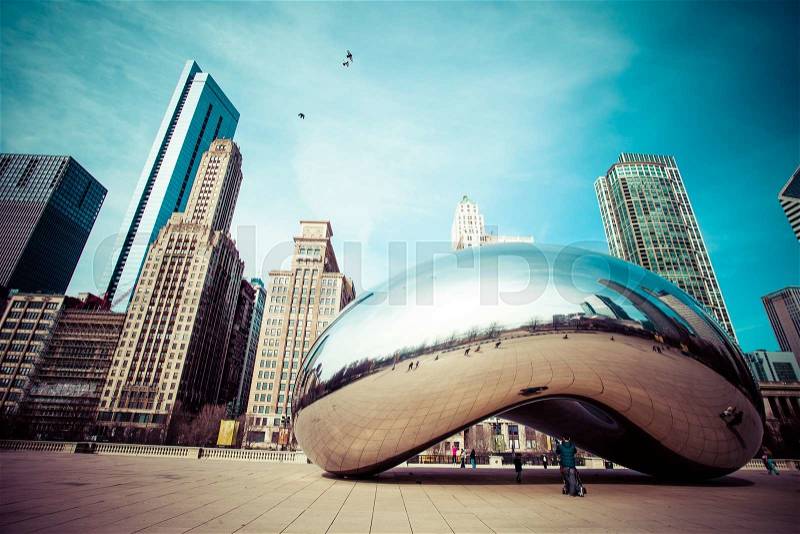 CHICAGO, IL - APRIL 2: Cloud Gate and Chicago skyline on April 2, 2014 in Chicago, Illinois. Cloud Gate is the artwork of Anish Kapoor as the famous landmark of Chicago in Millennium Park, stock photo