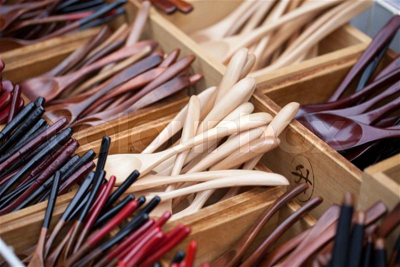 Wooden spoon small teaspoons new unused made of brown hard wood for sale on a street market in Thailand, stock photo