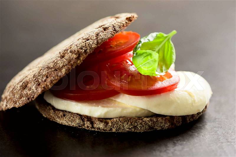 Sandwich with mozzarella, tomatoes and rye bread, stock photo
