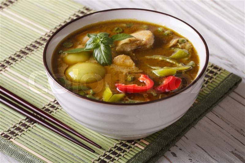 Thai cuisine: green curry chicken close-up on the table. horizontal , stock photo