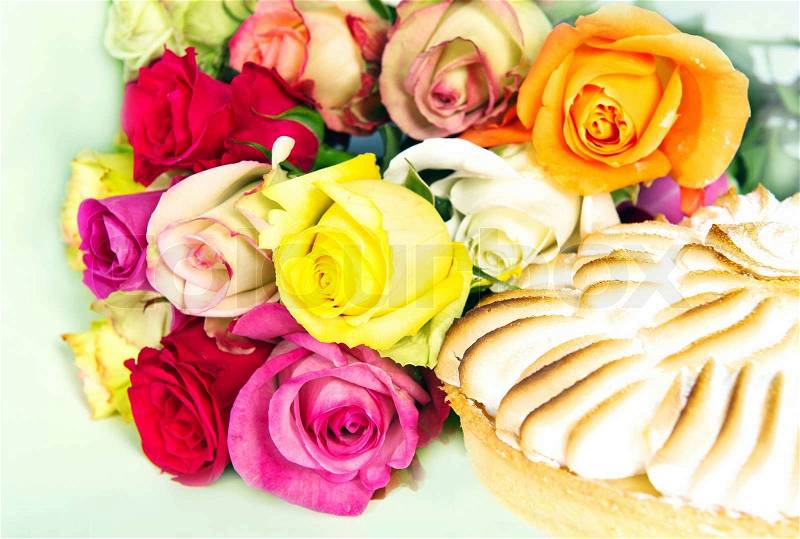 Bouquet of multicolored roses and cake, stock photo