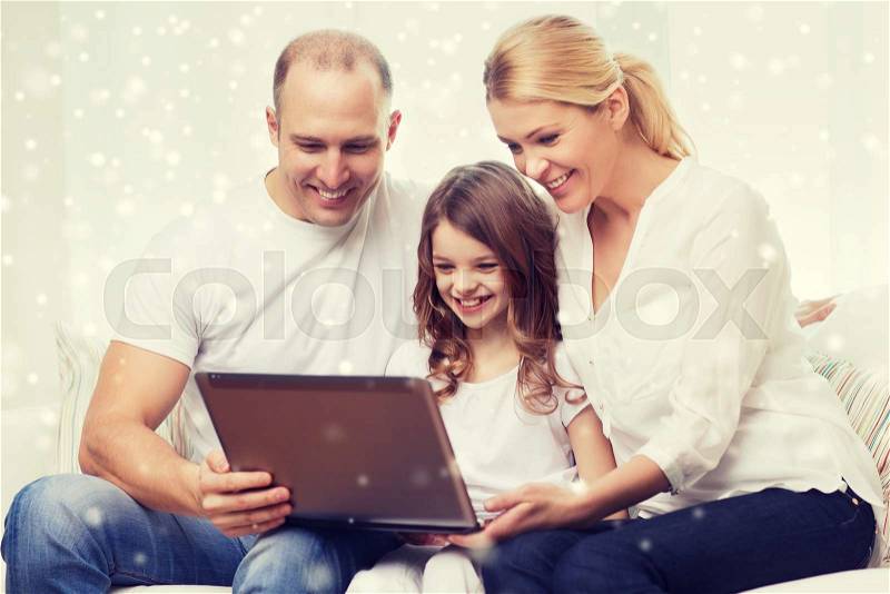 Family, childhood, technology and people concept - smiling family with laptop computer over snowflakes background, stock photo
