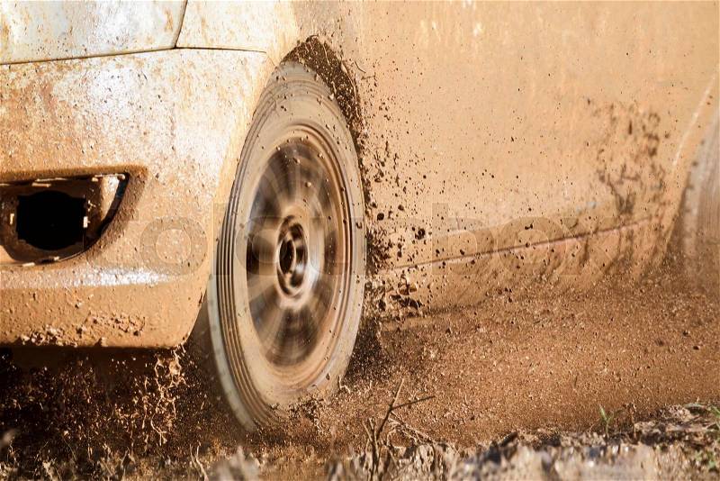 Rally car in muddy road, stock photo