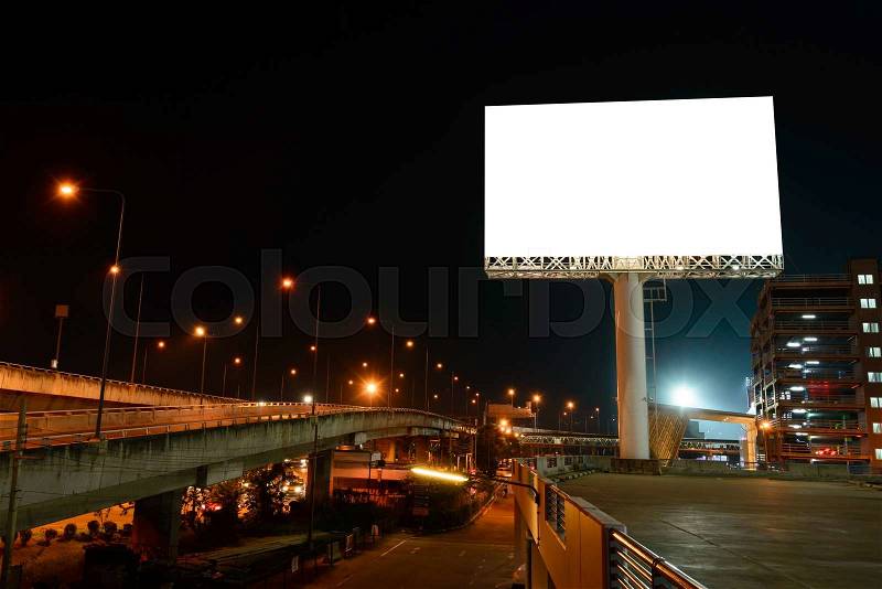 Blank billboard near expressway at night for advertisement, stock photo