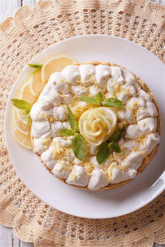 Beautiful lemon meringue cake close up on the table. vertical top view\, stock photo