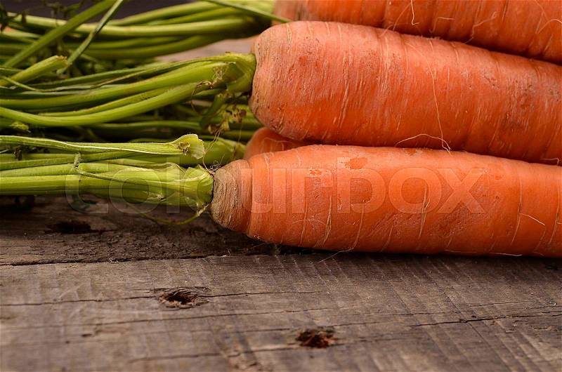 Close up of fresh raw organic carrots on old wood, stock photo