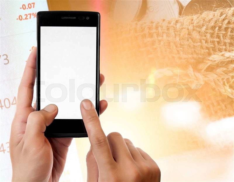 Hand holding smart phone on Money and the graph them,online banking make money concept, stock photo