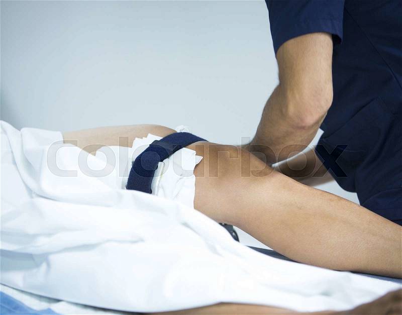 Traumatology orthopedic surgery hospital emergency operating room prepared for knee torn meniscus immobilised for arthroscopy operation photo, stock photo
