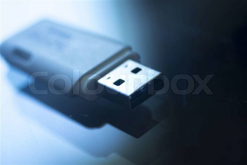 USB 3 flash drive III pendrive IT PC memory storage dongle plug socket close-up color artistic photo in blue tones, stock photo