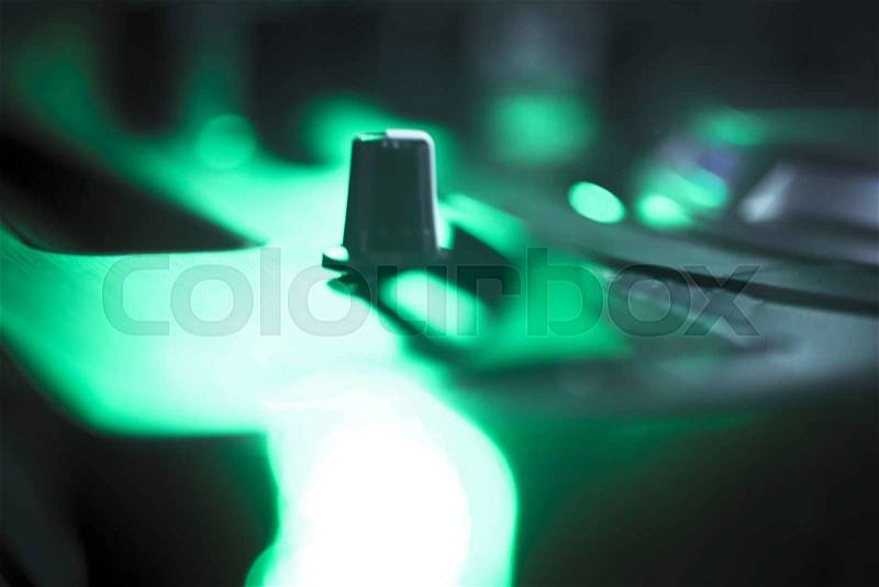 DJ console cd mp4 deejay mixing desk Ibiza house techno dance music wedding reception party in nightclub with colored lighting effect disco lights, stock photo