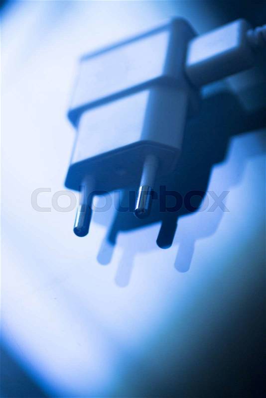 EU plug Euro European Union two 2 pin socket smart phone telephone charger cable close-up color artistic photo in blue tones, stock photo