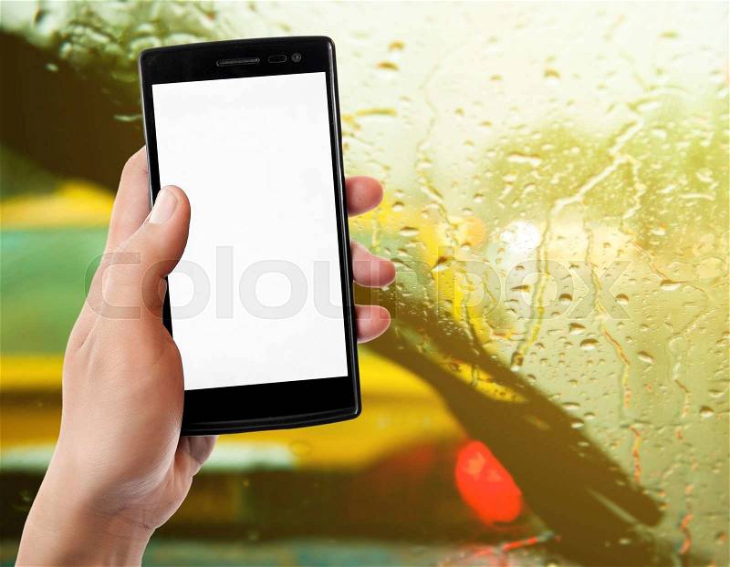 Hand holding smart phone on traffic jam background, stock photo