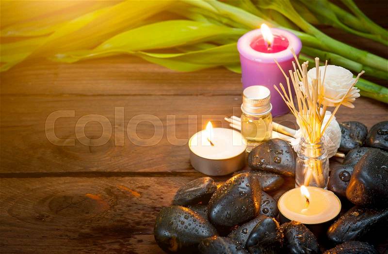Zen basalt stones, lavender candles on wooden,dark background,,Selective focus on candle, stock photo