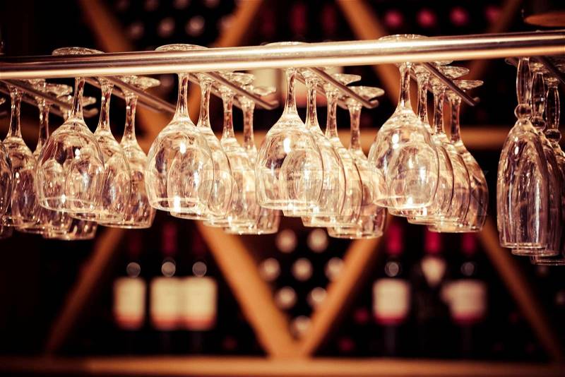 Empty glasses for wine above a bar rack , stock photo