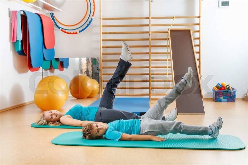 Happy, sports family, mother and son perform gymnastic exercises, stock photo