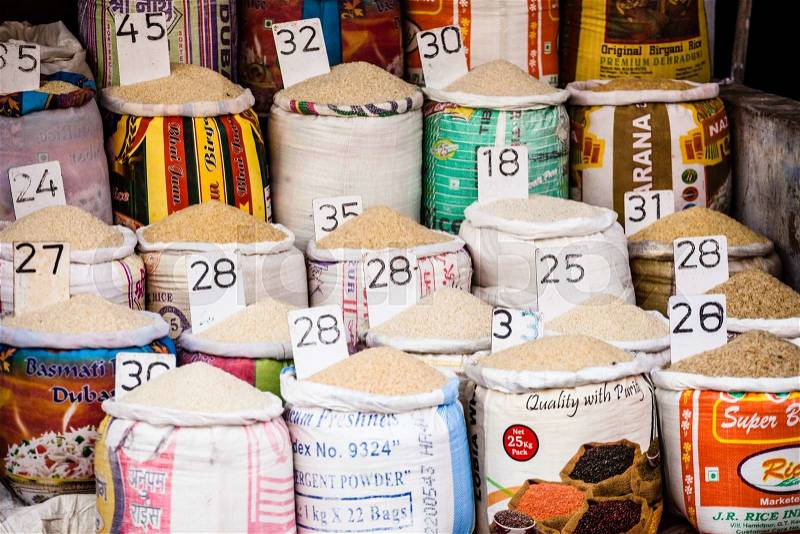 Close-up of bags of cereals and spices in a local country fair with italian names and prices, stock photo
