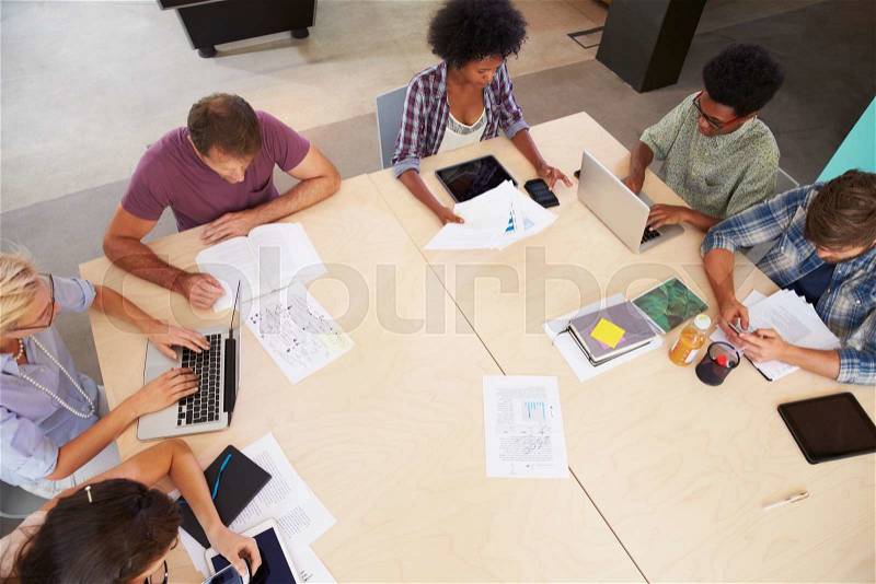 Overhead View Of Creative Brainstorming Meeting In Office, stock photo