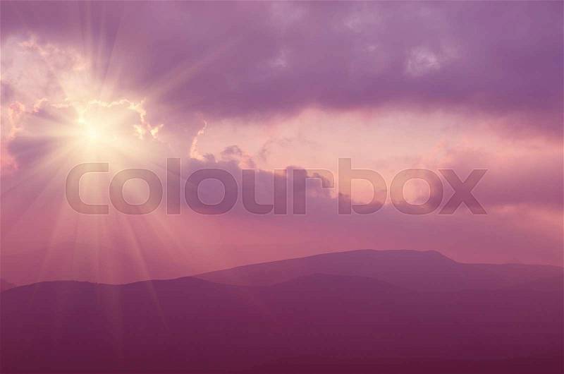 Carpathian mountains summer sunset landscape with sun in pink colors, natural background, stock photo
