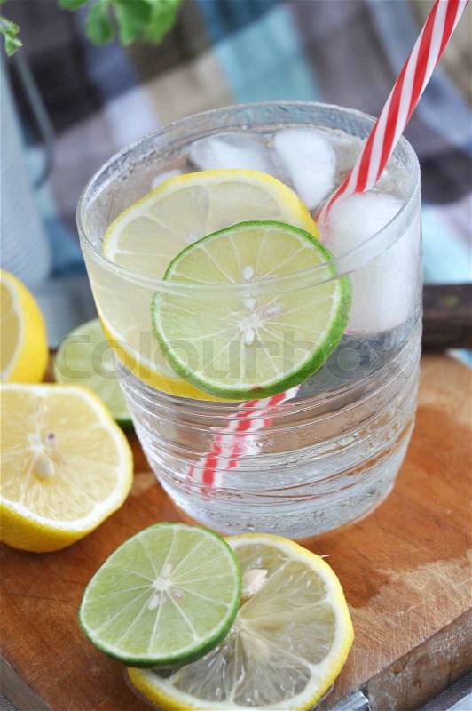 Close up lime and lemon in cool drink with red straw, stock photo