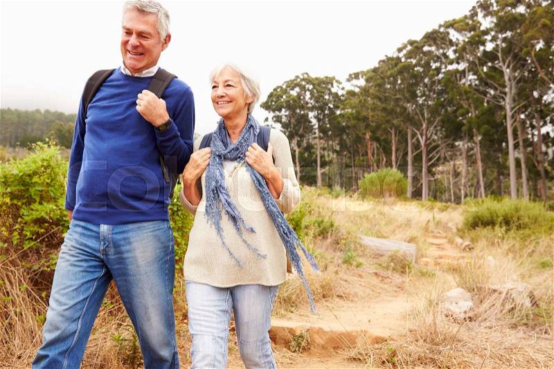 Senior couple walking together in a forest, close-up, stock photo