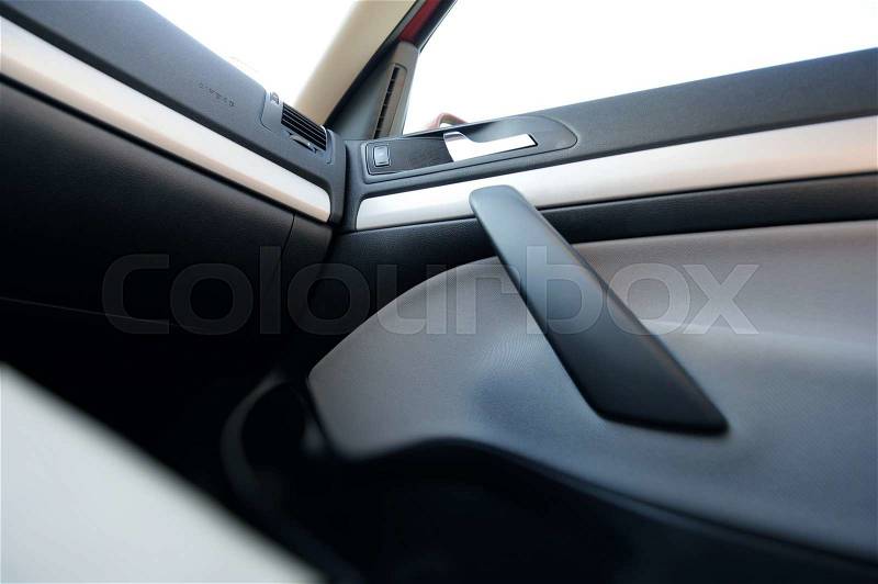 Interior of a modern car seen from inside with Airbag, door handler and other details, stock photo