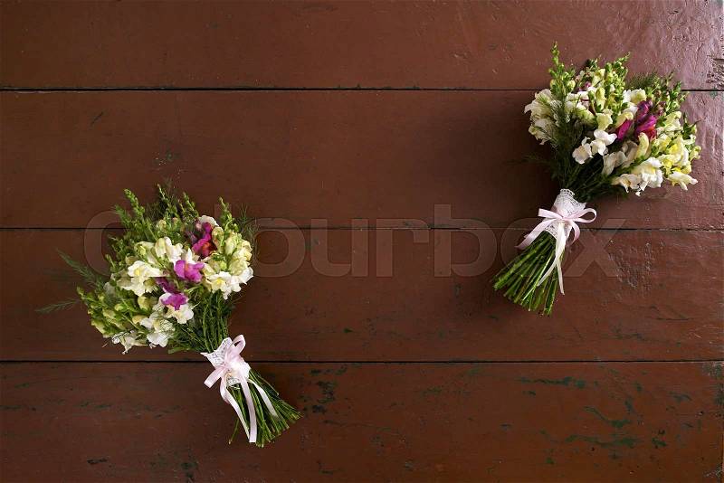 There are two handmade wedding bouquets on the table, stock photo