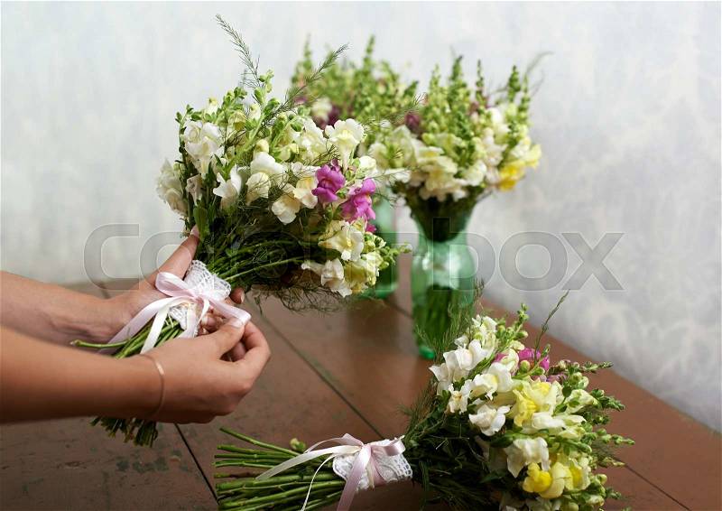 Florist make beautiful wedding bouquets, stock photo