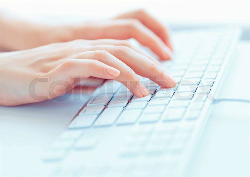 Female hands or woman office worker typing on the keyboard, stock photo