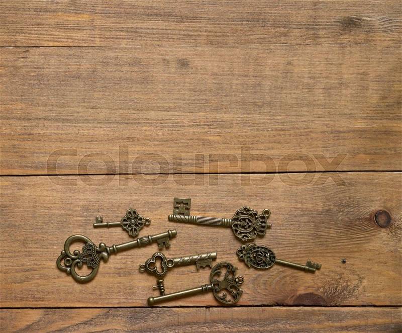 Old keys on wooden background, stock photo