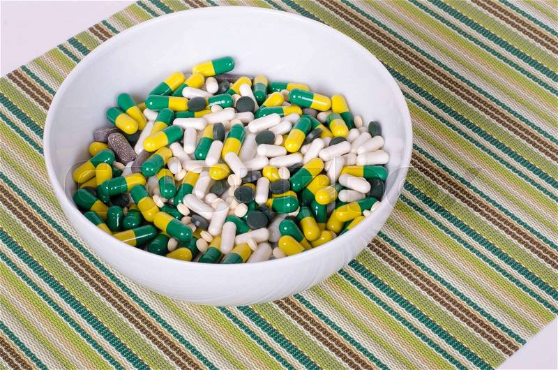 Plate of pills on striped cloth isolated, concept diet, diseases, stock photo
