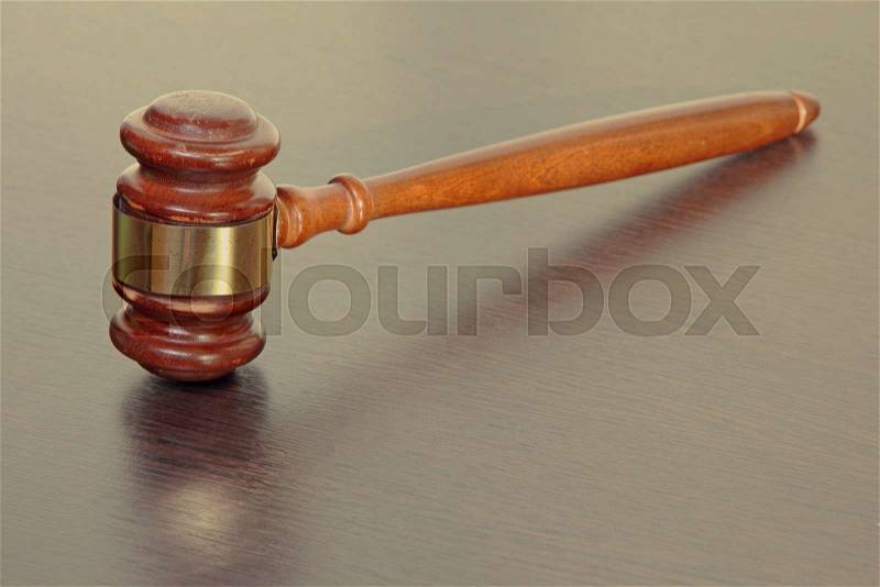 Judge gavel on wooden table in court taken closeup, stock photo