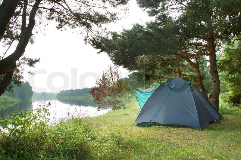 Tourist camping in the wilderness at the river, stock photo