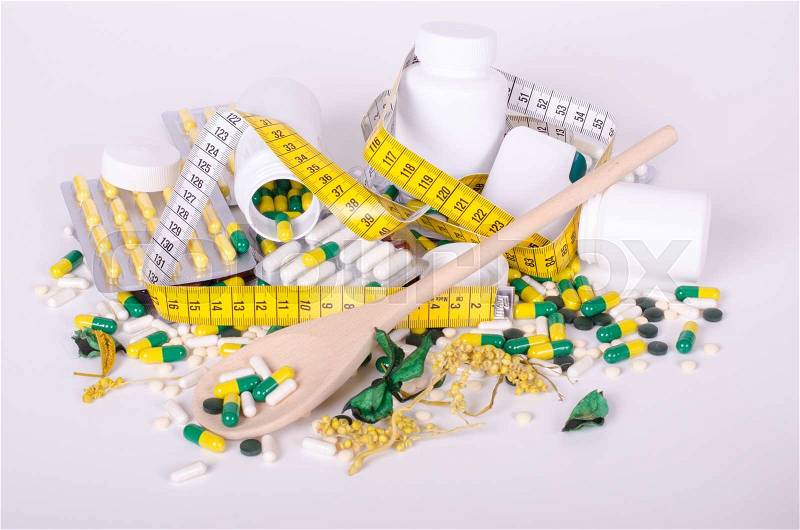 Pills and measuring tape isolated, wood spoone, concept diet, stock photo