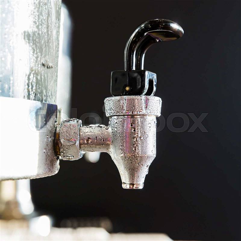 Close up water droplet on stainless steel cooler valve, stock photo