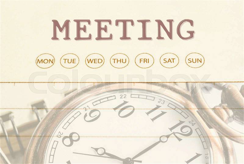 Close up meeting date on diary with pocket watch, stock photo