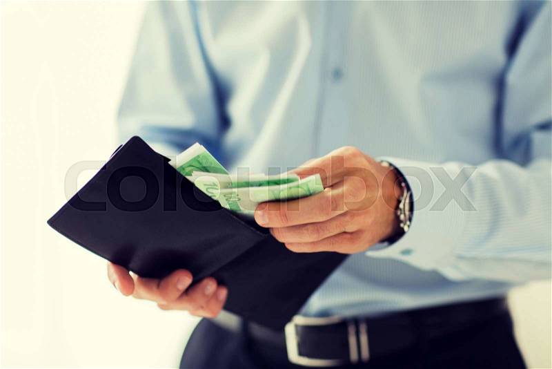 People, business, finances and money concept - close up of businessman hands holding open wallet with euro cash, stock photo