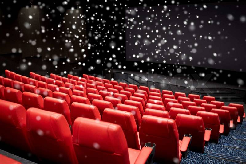 Entertainment and leisure concept - movie theater or cinema empty auditorium with red seats over snowflakes, stock photo