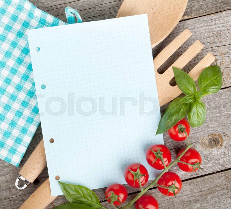 Blank notepad paper for your recipes with tomatoes and basil on wooden table, stock photo