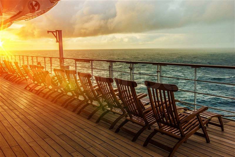 Cruise Ship Wooden Deck Chairs. Cruise Ship Main Deck at Sunset, stock photo