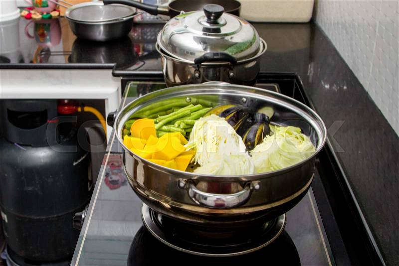 Pumpkin, cabbage, beans, eggplant in steaming pot, stock photo