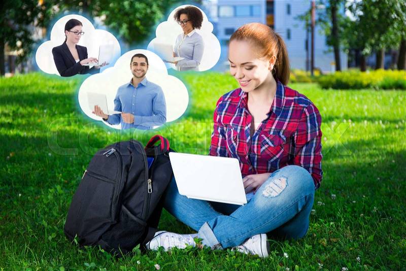 Social media concept - teenage student or school girl using laptop in park and clouds with her friends, stock photo