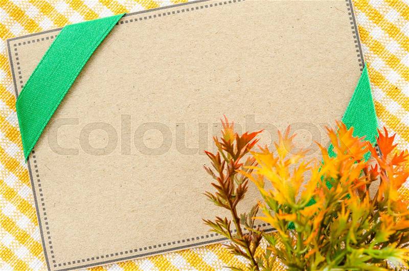 Blank brown paper tag for your text on beautiful fabric background, stock photo