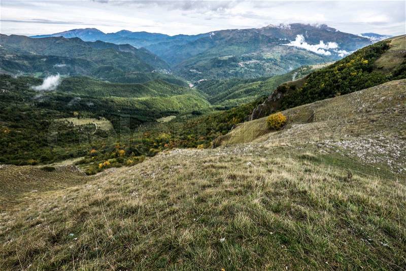 The green hills in the barren mountains of the Monti Sibillini in Umbria, Italy, stock photo