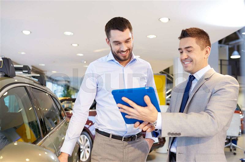 Auto business, car sale, technology and people concept - happy man and car dealer with tablet pc computer in auto show or salon, stock photo