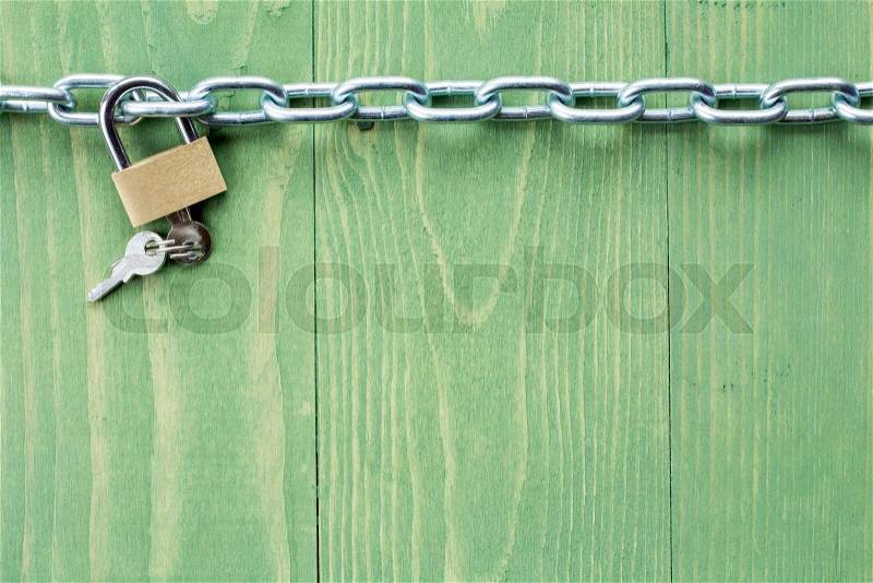 Chain and lock on green wooden background, stock photo