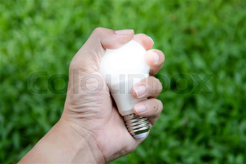 LED bulb - Energy in our hand with lighting, stock photo