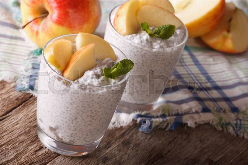 Homemade pudding with chia seeds and apples in a glass close-up on the table. horizontal , stock photo