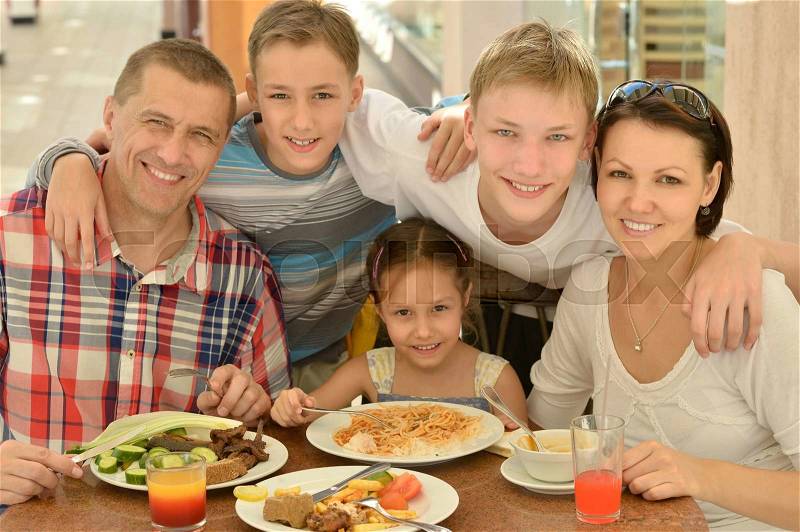 Happy family at breakfast on the table, stock photo